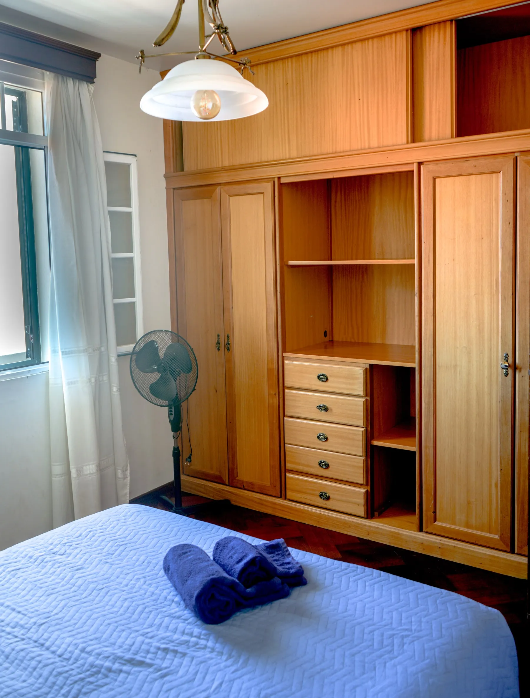 Linguine wooden wardrobe beside the window