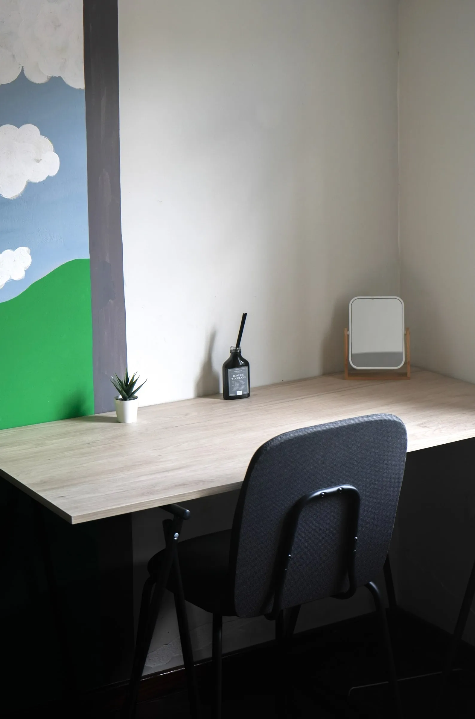 Orecchiette work desk and chair beside the landscape mural