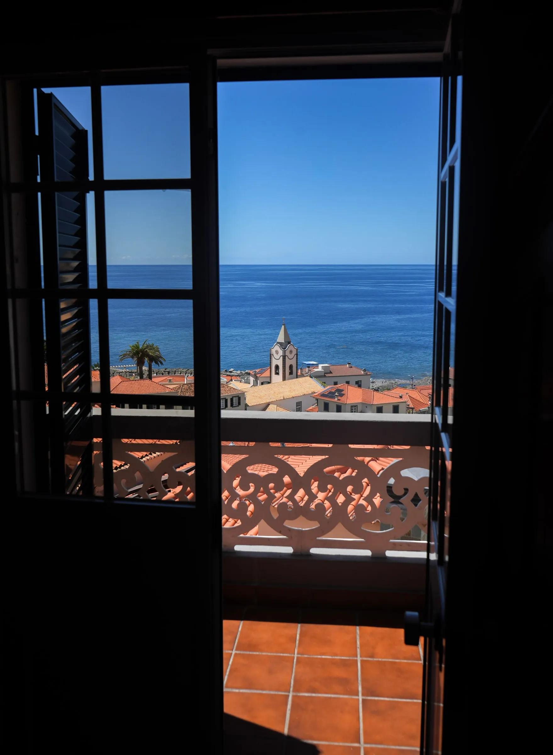 Ponta do Sol church and Atlantic Ocean through the Bucatini balcony door