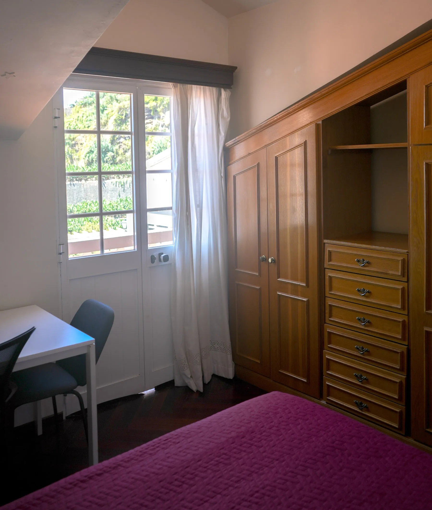 Bucatini wooden wardrobe and desk beside the balcony door